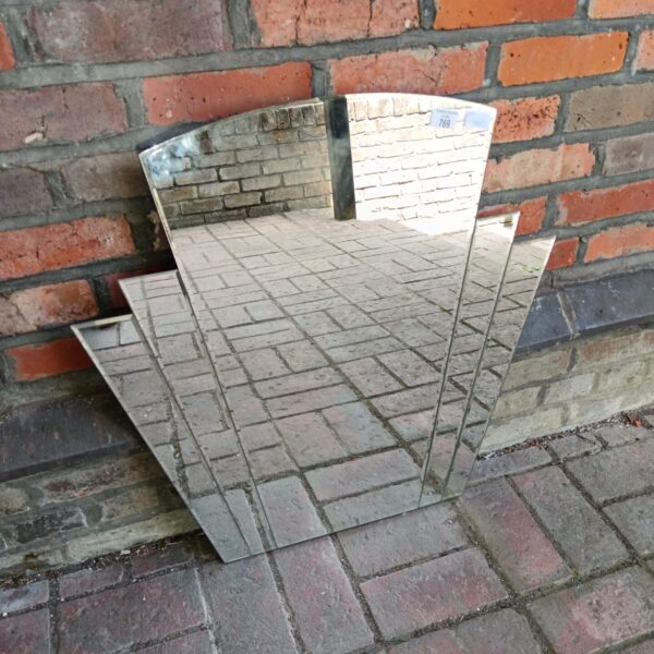 Vintage Art Deco mirror with bevelled edge and geometric design.