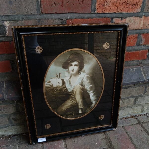Antique 1920s lithograph of a boy with a rabbit in a frame.