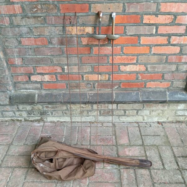 Vintage fencing épée and shafts, antique sporting equipment.