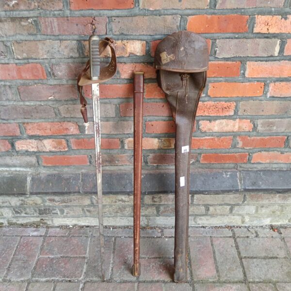 WWII officer's dress sword with leather scabbard, vintage military collectible.