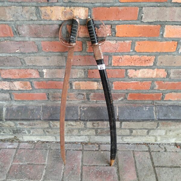 Pair of antique Indian swords with curved blades, a collectible display.