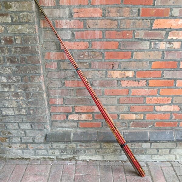 Vintage Pegley Davies fishing rod in warm brown tones.