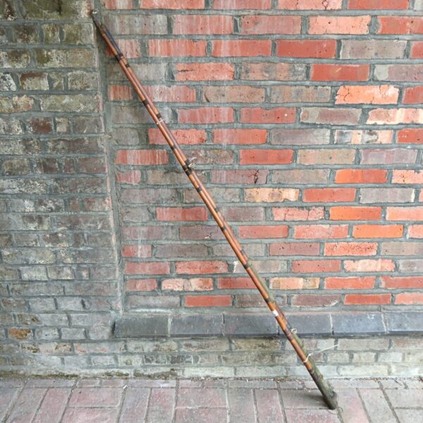 Vintage cane fishing rod for sea angling, showing classic construction.