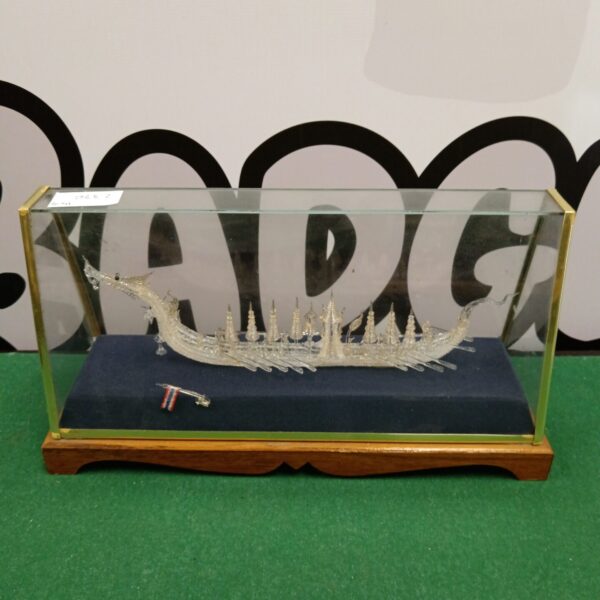 Detailed glass Chinese dragon boat displayed in a protective case.