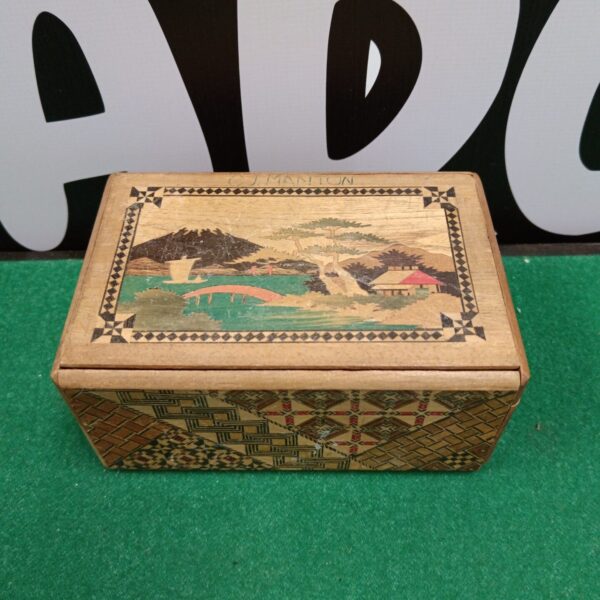 Vintage Japanese marquetry puzzle box with landscape inlay.