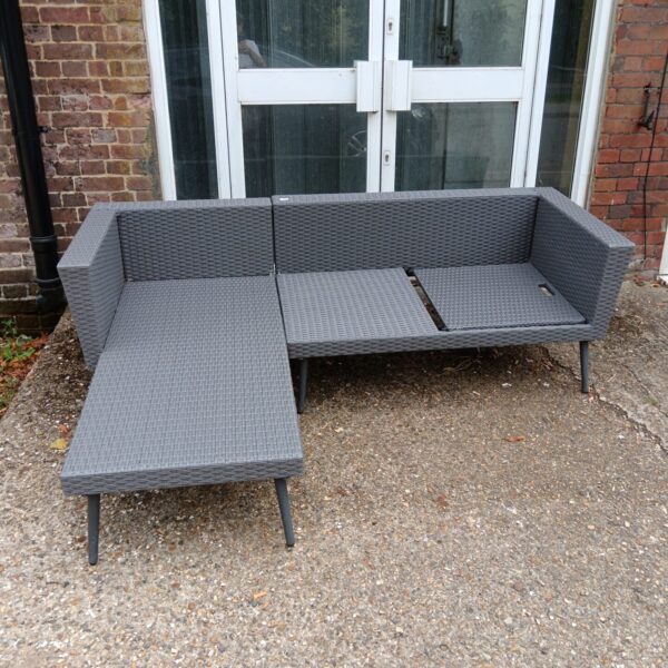 Contemporary L-shaped rattan garden sofa for outdoor use.