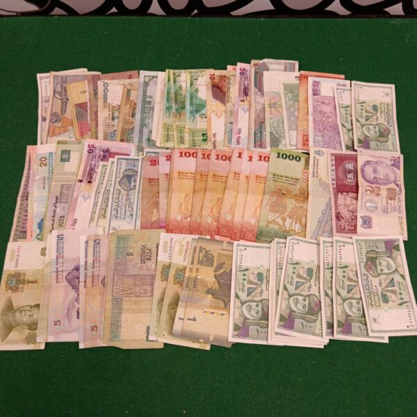 Diverse collection of foreign bank notes and world currency.