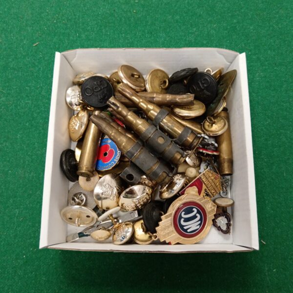 Mixed lot of vintage badges, bullets, and buttons for collectors.
