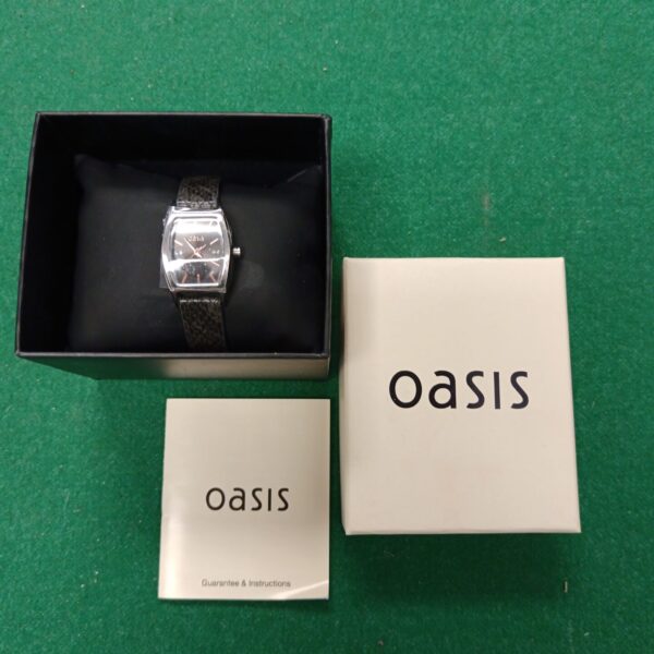 Oasis ladies watch in original box, silver case, black strap.