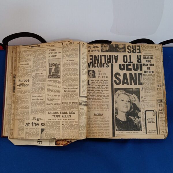 Vintage newspaper scrapbook cover at auction, 1950s-1960s ephemera.