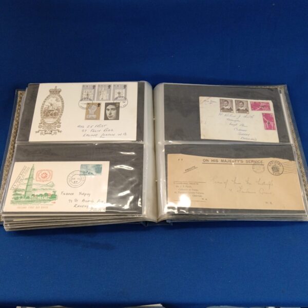 Open folder displaying vintage British first day covers.