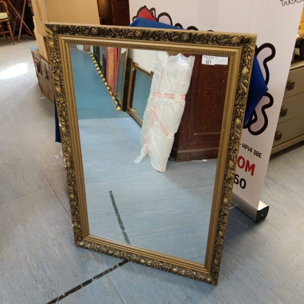 Ornate gilt framed mirror, antique wall decor.