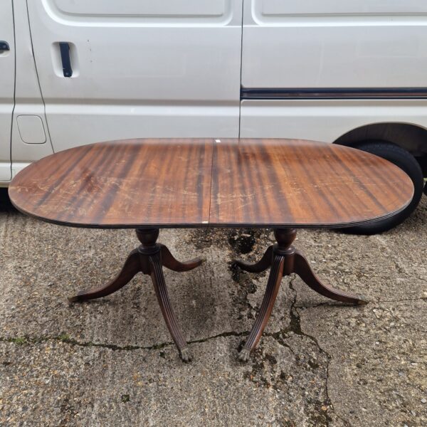 Antique mahogany dining table with hinged leaf, full view.