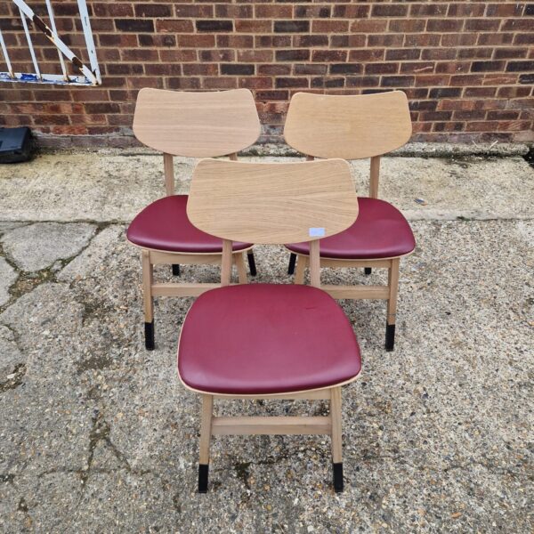 Three red vinyl designer style chairs with beechwood frames.