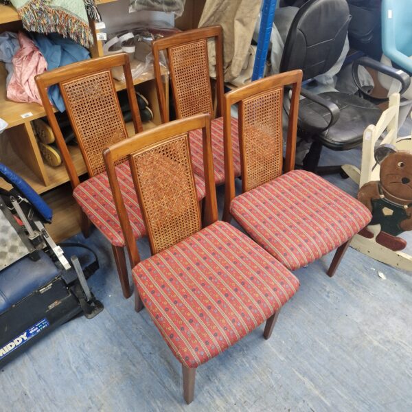 Set of four vintage floral dining chairs in a dining room setting.