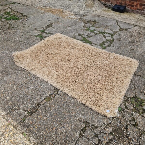Close-up of a soft, textured shag pile rug.