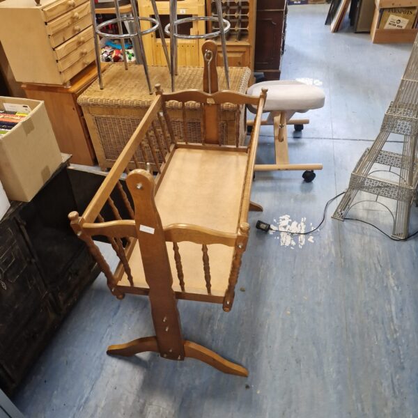 Vintage Serenade Babies cot with wooden spindles.