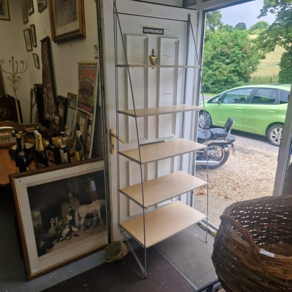 Five-tier metal ladder shelving unit in a room setting.