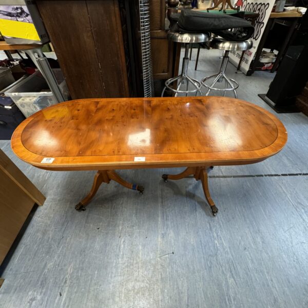 Vintage burr walnut coffee table with turned pillars.