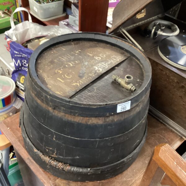 Antique port half barrel with metal bands, rustic storage.