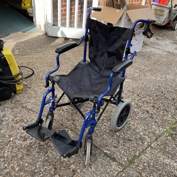 Blue folding wheelchair with footrests, a practical mobility aid.