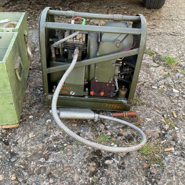 Vintage military field charging set with engine and connections.