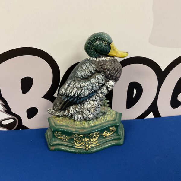 Antique cast iron duck doorstop with detailed feathering.
