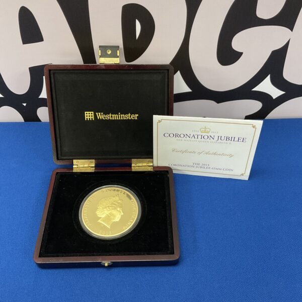 Westminster Coronation Jubilee gold plated coin in display case.