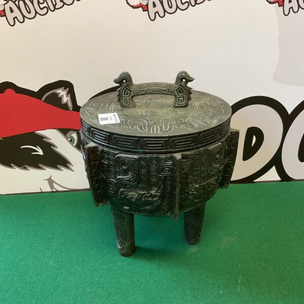 Vintage South American ice bucket with intricate metal carvings.