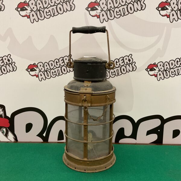 Antique vintage stable lantern with metal frame and glass panels.