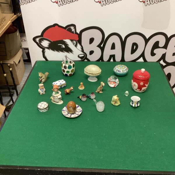 Assortment of vintage trinket boxes and miniature ornaments on display.