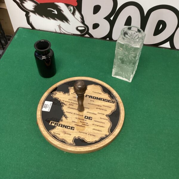 Vintage French cheeseboard with decorative vases for serving cheese.