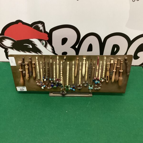 Vintage cotton bobbin display on a copper background.