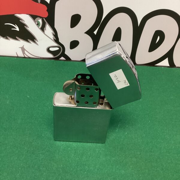 Vintage IZ table lighter with a polished metal finish.