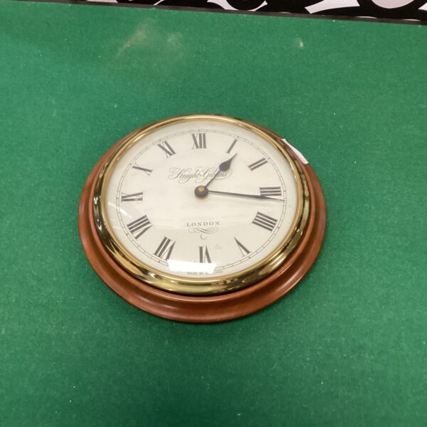 Vintage Knight and Gibbins wall clock with Roman numerals.