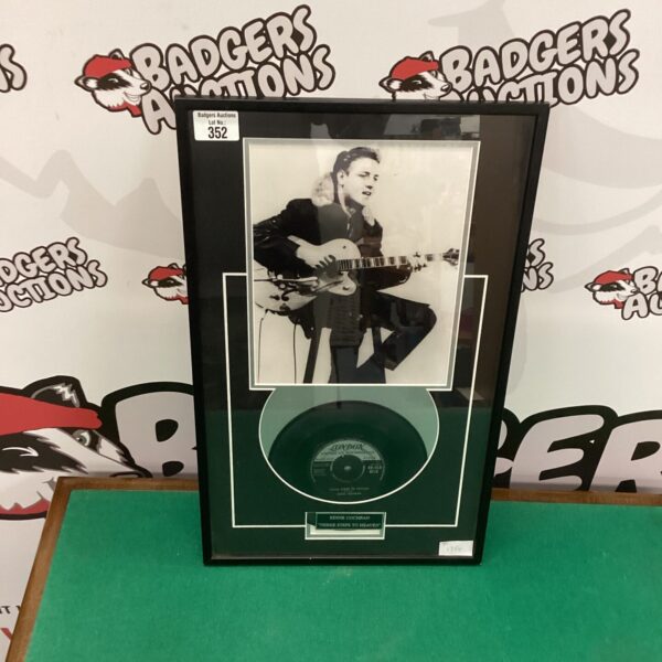 Framed Eddie Cochran record and photo, vintage rock and roll memorabilia.