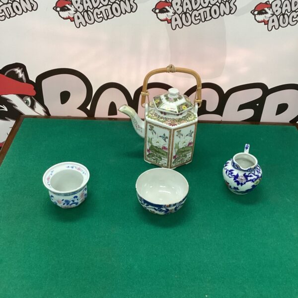 Antique Japanese tea pot with a vibrant lotus design.