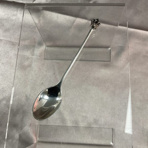 Danish silver teaspoon displayed in a clear case.