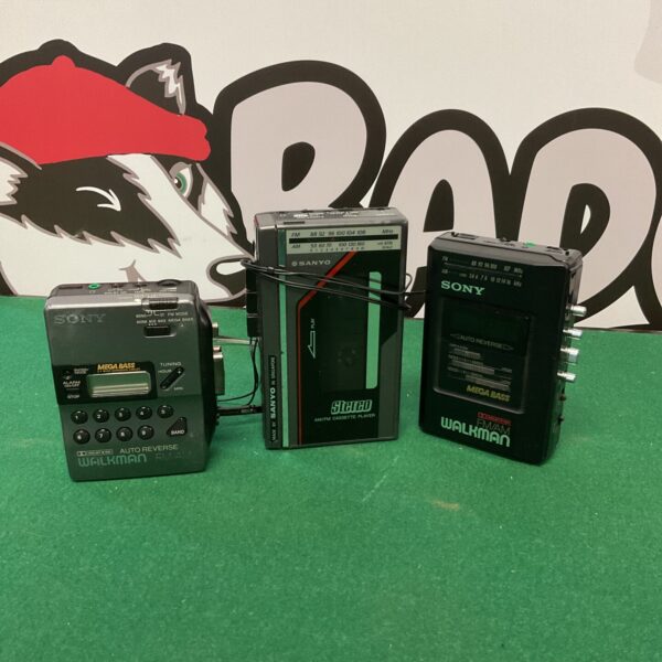 Vintage cassette player lot featuring Sony Walkman and Sanyo radio.