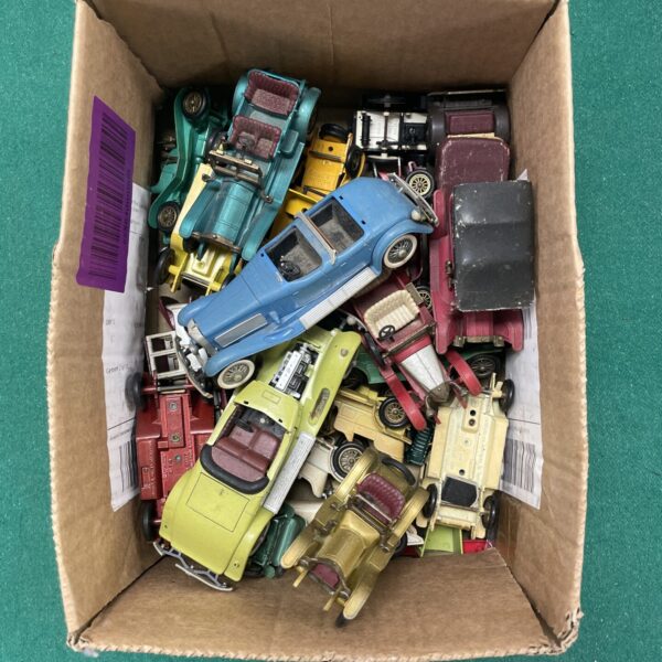 Vintage diecast model cars in a collection, showing signs of wear.