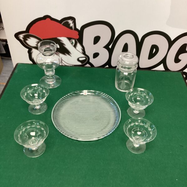 Vintage glass sundae set with tea light holder on display.