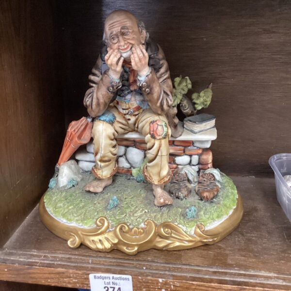 Vintage porcelain old man bench figurine, detailed character collectible.