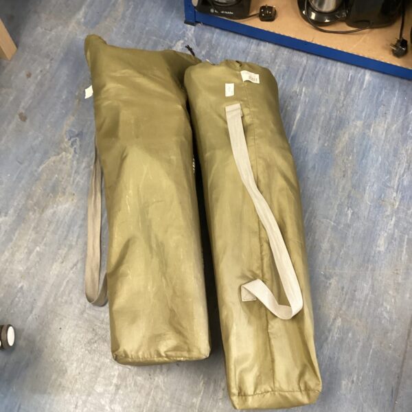 Two camping folding chairs in carry bags, ready for outdoor use.