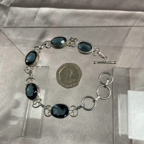 Close-up of 925 silver bracelet with large blue crystals.