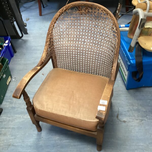 Vintage rattan back chair with wooden frame, farmhouse style.