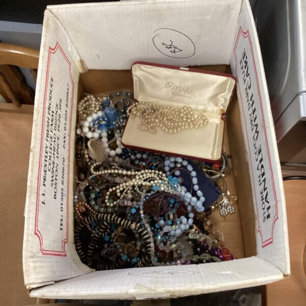 Costume jewellery lot with necklaces and bracelets on display.
