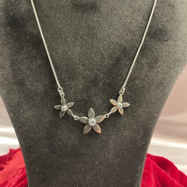 925 silver necklace with three blue stone flower pendants.