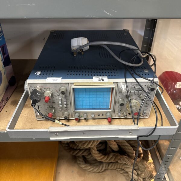 Vintage Tektronix oscilloscope with analogue display and controls.