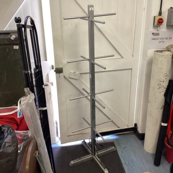Vintage metal hat rack in a hallway setting.