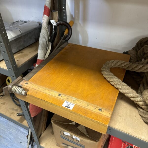 Vintage paper guillotine with wooden base and graduated scale.